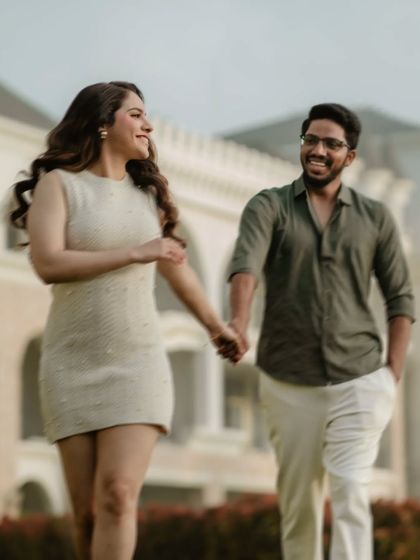 A happy, candid shot of a couple walking hand-in-hand in Thailand. Their joyful expressions and natural movement are the essence of our unposed photography style.