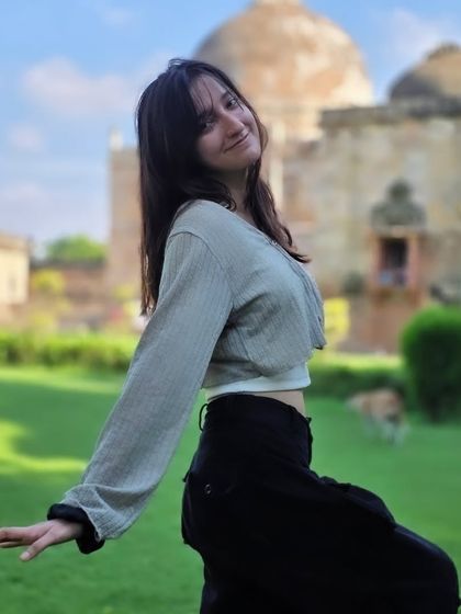 A fun, dynamic pose that shows off her personality. The low angle and the backdrop of Lodi Garden's tomb create a powerful and playful composition.