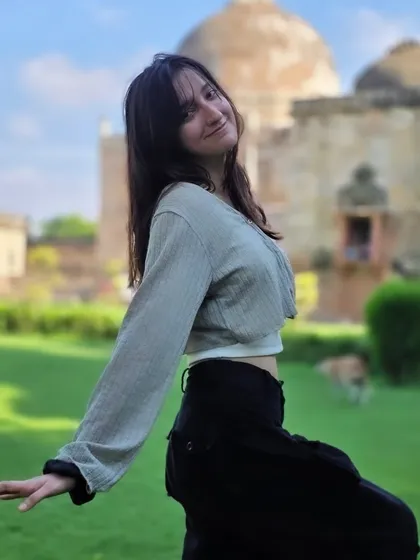 A fun, dynamic pose that shows off her personality. The low angle and the backdrop of Lodi Garden's tomb create a powerful and playful composition.