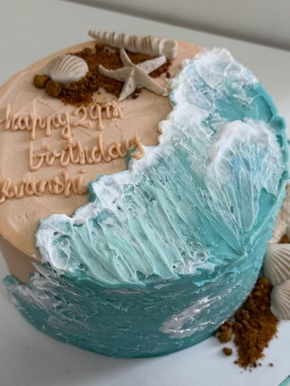 Bringing the calm of the ocean to a celebration. This beach-themed cake features beautifully textured buttercream waves and sandy details, creating a seaside escape in dessert form.
