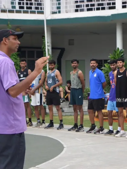 A coach addressing a group of players during the tryouts, providing guidance and evaluating talent.