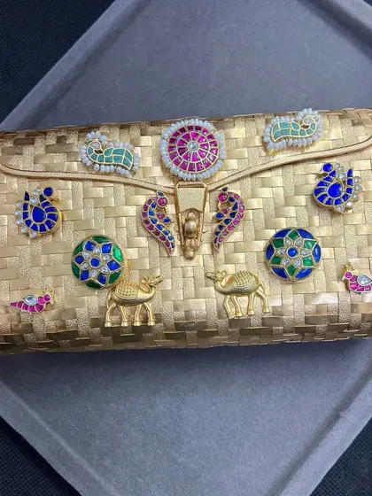 Another look at the stunning gold-plated fusion clutch. The basket-weave texture of the silver base provides a beautiful backdrop for the vibrant, hand-placed motifs.