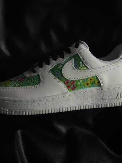 A custom Nike Air Force 1 featuring a vibrant, pointillism-style flower field design.
