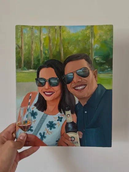 A hand-held view of the finished "cheers" portrait. The reflections in the sunglasses were a fun detail to paint, adding to the realism of the scene.