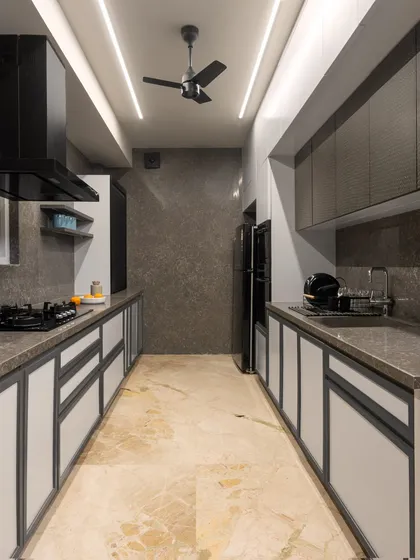 For our modern loft kitchen, we opted for a sleek, parallel layout with a monochromatic theme. Minimalist lighting and quartz countertops enhance both the functionality and aesthetics of the space.