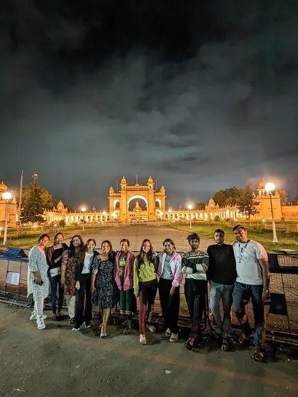Our group visiting the beautifully lit Mysore Palace at night during our Wayanad trip.