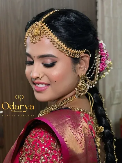 This angle highlights the detailed hair accessories and the flawless blend of the makeup. The winged eyeliner and glowing skin are key elements of my signature South Indian bridal service.