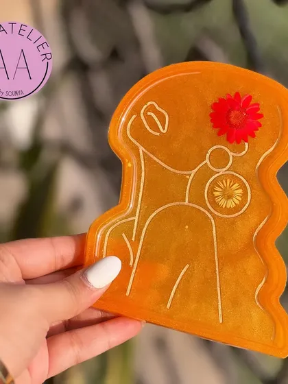 This sunny orange lady trinket tray is sure to brighten up any room. The real flowers embedded in the resin add a unique, natural touch.