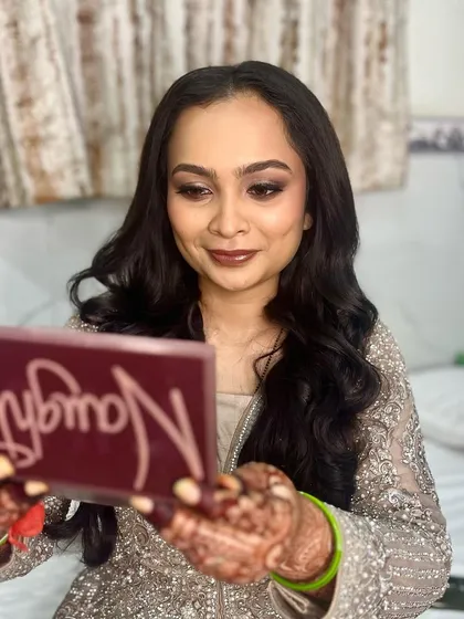 The "first look" in the mirror moment. Her reaction says it all. This is the power of a great glam session.