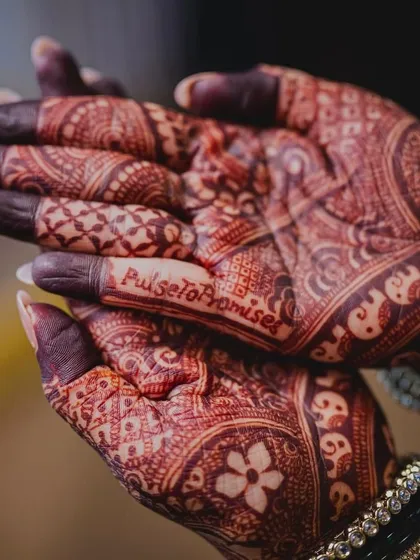This bride, a doctor, chose the hashtag "PulseToPromises." We incorporated it right into her intricate bridal mehendi, blending her profession with her new journey.