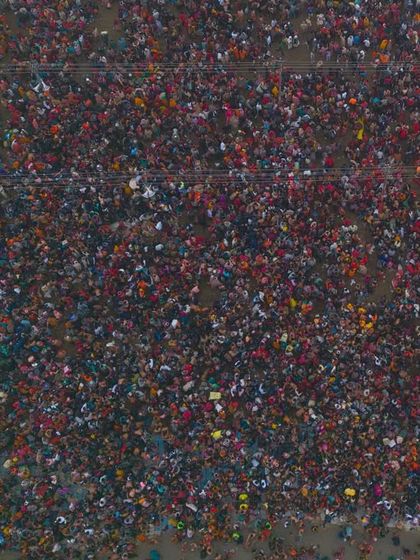 A direct top-down shot of the devotees during the Shahi Snan. This perspective highlights the sheer density of the crowd, a powerful visual of collective faith.