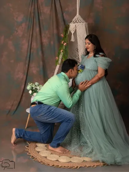 A kiss for the bump is always a heartwarming moment. Here, the swing setup provides a unique and romantic setting for this classic couple pose.