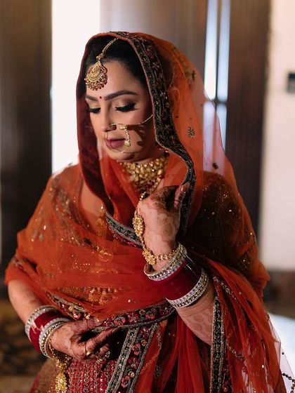 A beautiful portrait of the bride with her dupatta, showcasing the soft yet defined eye makeup.