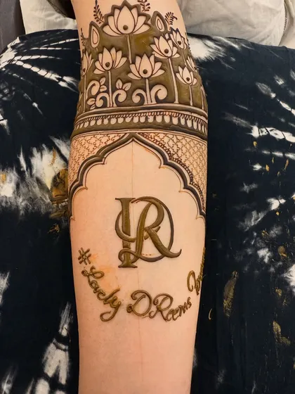 The completed armband design, featuring a space for the couple's initials 'DR'. This combines a beautiful floral pattern with a personal touch, perfect for a groom's forearm.