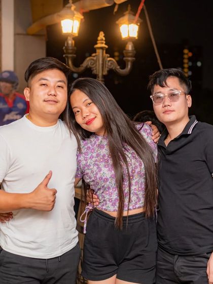 A group of friends enjoying the rooftop seating.