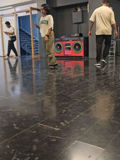 A student practicing during an SDDP session, with the iconic boombox in the background.