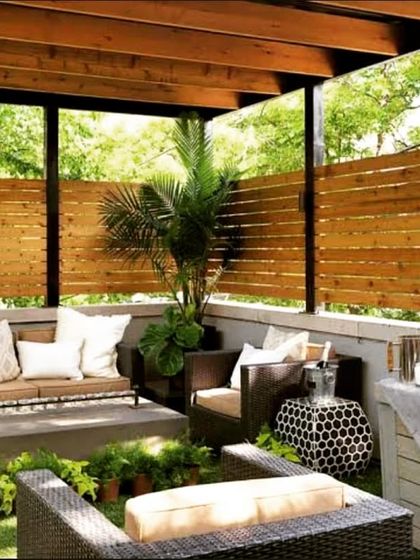 For this project, we used wooden privacy screens and comfortable wicker furniture to create an intimate and cozy seating area. The surrounding greenery makes it feel like a private retreat, even in a residential neighborhood.