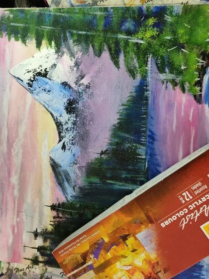 A landscape painting in progress, showing the materials and setup for one of our guided acrylic sessions.