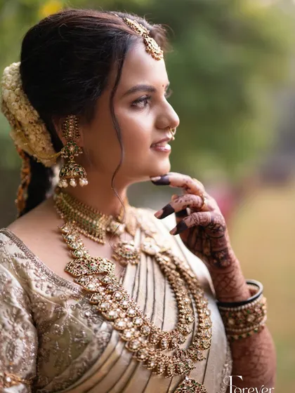 A profile shot capturing a happy, natural expression and the beautiful details of her jewellery.