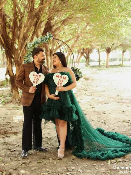 A fun and cute shot with the couple holding "Mom to be" and "Dad to be" signs. Props like these are a great way to announce your excitement to the world.