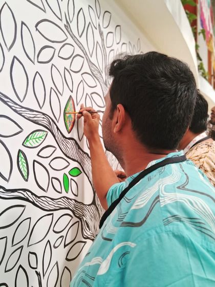 The 'Mosaic of Us' tree mural was a collaborative piece created during the Hearth Summit. I painted the outline, and attendees brought it to life by coloring in the leaves. It stands as a beautiful symbol of how individual contributions create a vibrant, collective whole.
