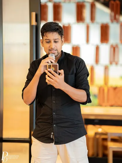 A performer reads from his phone, his expression focused. The event was a testament to the safe space our community has built.