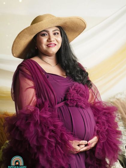 This portrait showcases a stylish boho look with a rich plum gown and a wide-brimmed hat. We bring all the elements, including the backdrop and props, to create this vibe at your home.