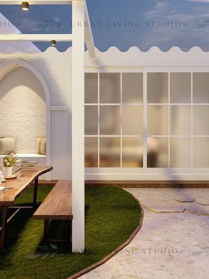 This Pitampura design includes a rustic wooden dining table and benches on a patch of lawn, with arched niches in the wall for a touch of vintage charm.