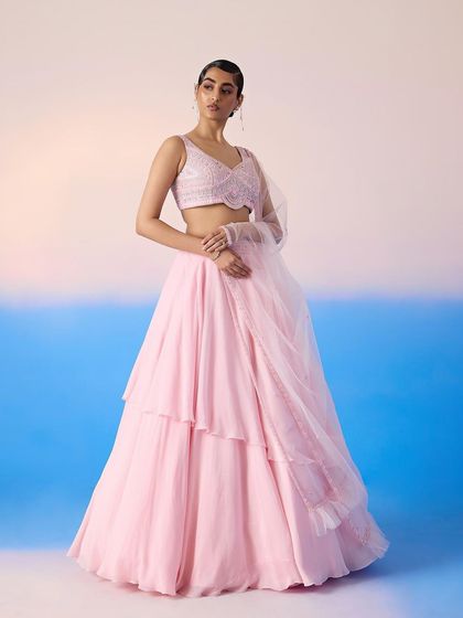 Another view of the pink tiered lehenga, highlighting its graceful movement and soft silhouette.