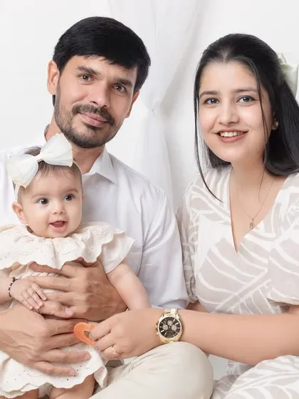 A beautiful, classic family portrait with everyone looking happy and relaxed.