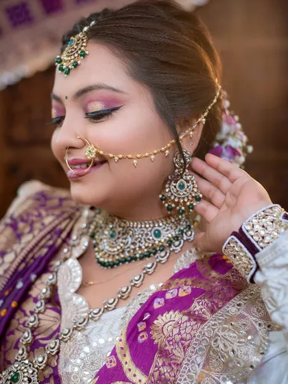 A close-up of a Gujarati bridal look, highlighting the traditional nath and the soft, radiant makeup.