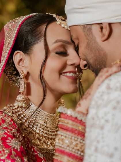A tight close-up capturing the pure joy and love in the couple's smiles on their wedding day.