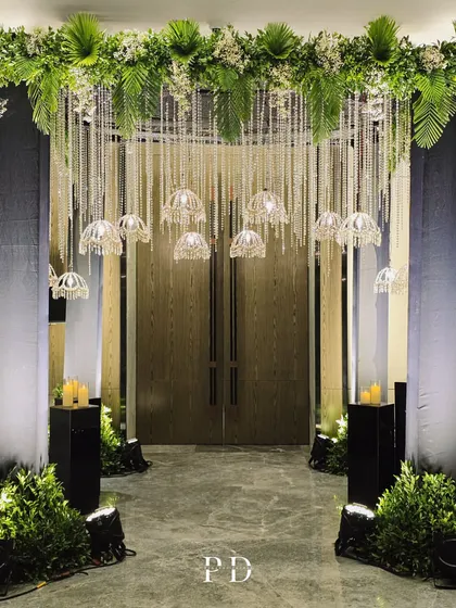A straight-on view of the crystal and greenery entrance, creating a perfectly symmetrical and grand welcome for a glamorous Sangeet night.