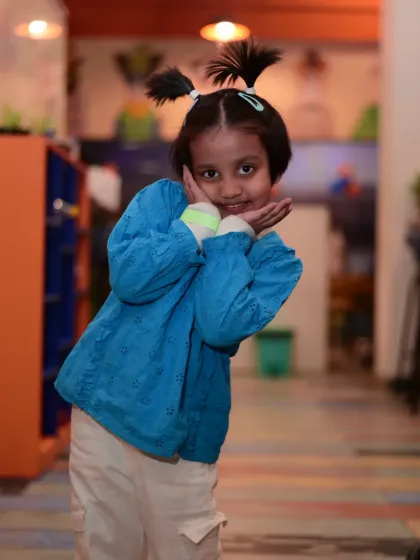 A young guest with a cute hairstyle posing for the camera. Every child gets to feel like a star.