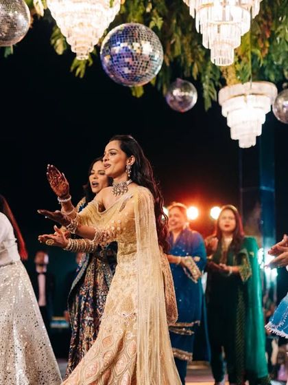 A close-up of the bride and her family members during their group sangeet performance. You can see the happiness and energy as they dance together, a moment made possible through virtual lessons.