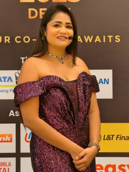 Posing against the backdrop of event sponsors at the BASIC Huddle. I understand the importance of acknowledging partners and integrating them smoothly into the event's proceedings.