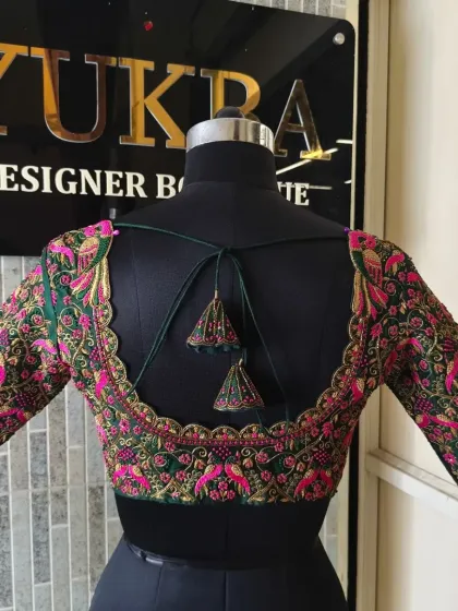 A back view of the fully embroidered green blouse, showcasing the craftsmanship and the flattering cut.