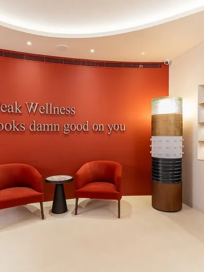 For the ZOII wellness club in Gurugram, we shaped an experience rooted in tranquility. The entrance makes a bold yet grounding statement with an earthy red curved wall and custom-designed velvet armchairs. This space was designed to hold and ground its visitors, offering a quiet gesture in a loud city.