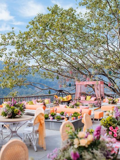 The vibrant and colorful Mehendi decor overlooking the mountains at The Den, Corbett, showcasing a perfect blend of celebration and nature.
