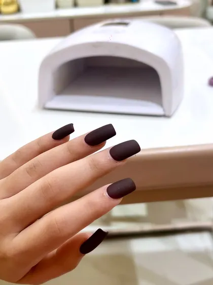 A chic and sophisticated matte chocolate brown manicure. The matte finish gives this classic color a modern and trendy feel.