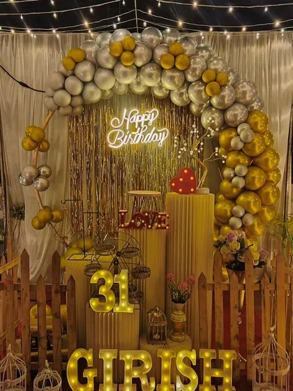 Don't have a large venue? No problem. We can transform any space, like this terrace, into a beautiful party spot with a canopy of fairy lights, a stylish balloon arch, and a personalized backdrop for a memorable birthday surprise.