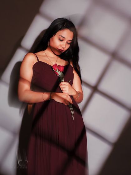 A beautiful, introspective moment. The soft focus and the grid of shadows create a dreamlike atmosphere, as if capturing a memory.