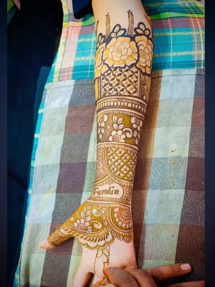 A clear side view of the personalized henna, focusing on the intricate details of the forearm bands.