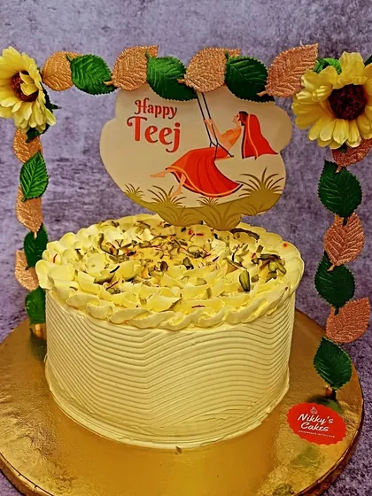 I enjoy creating fusion cakes that celebrate our festivals. This is my special Rasmalai cake, made for Teej, featuring the rich flavors of the classic Indian sweet, garnished with pistachios, and decorated with a festive topper.