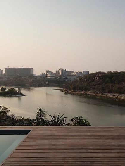 The reward for the concealed entry: an expansive, uninterrupted view of the lake and Hyderabad's hi-tech city from the home's wooden deck and infinity pool.