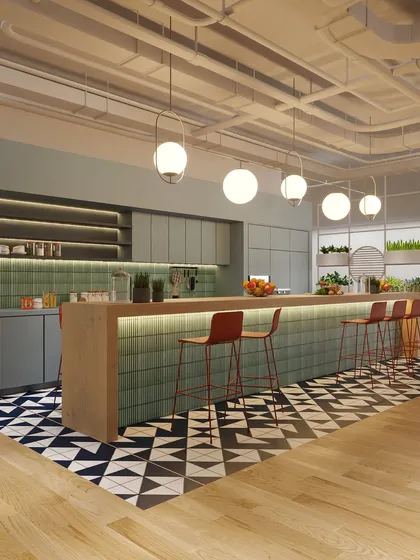 A different angle of the pantry, showing the ample counter space and stylish globe pendant lights. It’s a perfect spot for grabbing a coffee and catching up with colleagues.