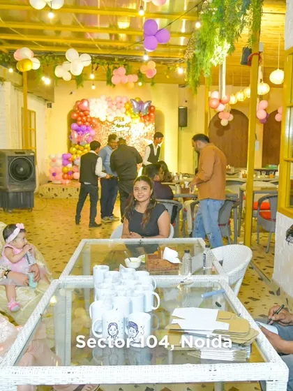 A wide shot of our dining area during a party, showing families enjoying their meals in a festive, decorated setting.