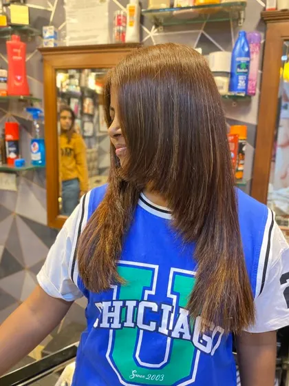 This client's new balayage colour looks fantastic with her layered haircut. The colour placement highlights the movement in her hair.