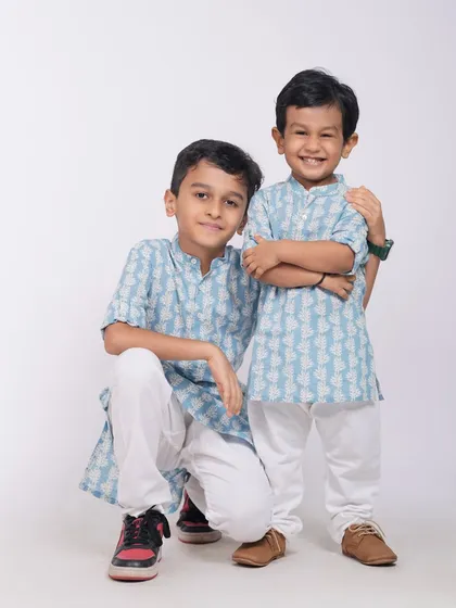 A heartwarming portrait of two brothers, with the older one protectively holding his younger sibling. A perfect capture of brotherly love.