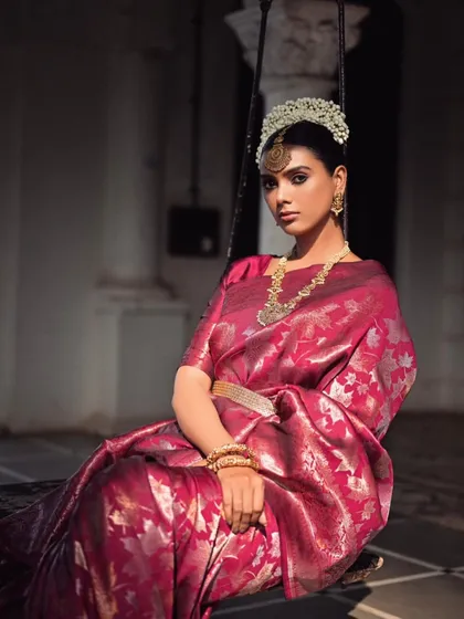 The saree is a canvas of elegance. Here, I've styled a rich magenta Banarasi silk saree, cinched at the waist with a delicate gold belt to accentuate the form. The look is elevated with traditional temple jewellery and a floral headpiece, creating a look that is both regal and rooted in Indian heritage.